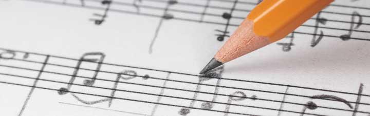 Image of writing notes on sheet music with a pencil