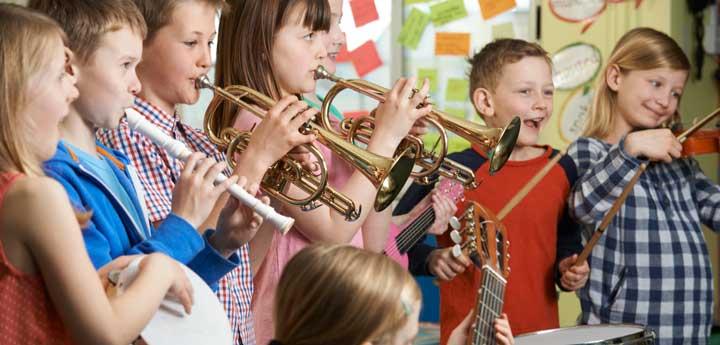 Image of children playing instruments in a classroom