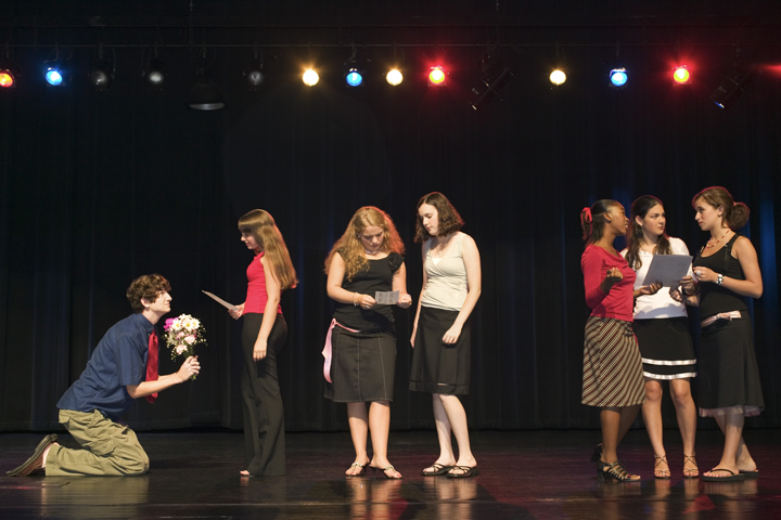 Students on stage reading lines